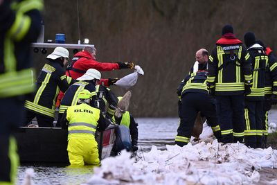 Towns reinforce dikes as heavy rains send rivers over their banks in Germany and the Netherlands
