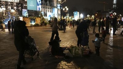 Paris City Hall plaza draws holiday visitors and migrant families seeking shelter as Olympics nears