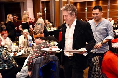 ‘This was the real Love Actually’: Hugh Grant surprises 500 elderly residents by serving Christmas dinner