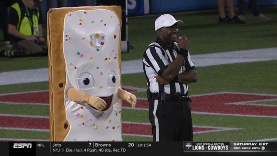 The PopTarts Bowl mascot menacingly creeping behind a…