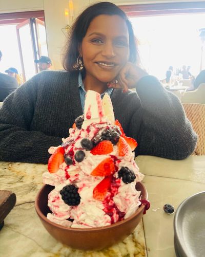 Mindy Kaling Delights with Joyful Smile and Tempting Dessert