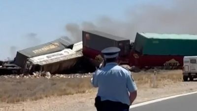 Driver charged over two killed in truck and train crash