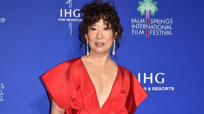 Sandra Oh is a vision in fiery red dress and crystal drop earrings as she kicks off 2024 red carpet season in style at Film Festival Awards