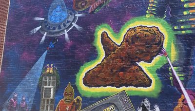 Aliens, monsters dominate Berwyn mural, but what’s with the chicken wing shooting a laser?