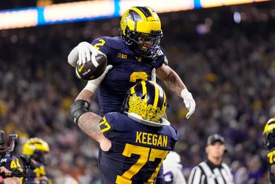 Jim Harbaugh delivers a national title. Corum scores 2 TDs, Michigan overpowers Washington 34-13