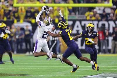 Washington’s Ja’Lynn Polk stayed and watched Michigan’s championship trophy ceremony creating a heartbreaking photo