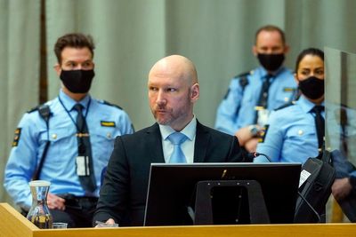 Mass killer who says his rights are violated should remain in solitary confinement, Norway says