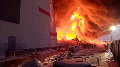 A huge fire engulfs a warehouse in Russia outside the city of St Petersburg