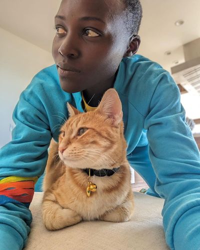 Lupita Nyong'o's Playful Social Media Selfies with Feline Companion