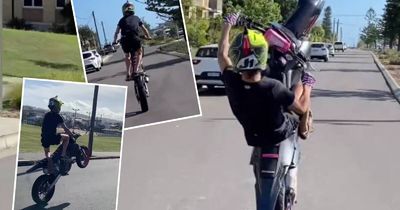 Rogue motorbike riders film 'dangerous' stunts on beachside streets