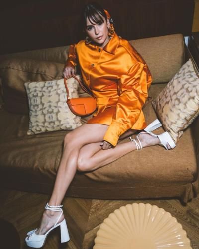 Nina Dobrev Stuns in Vibrant Orange Outfit and White Heels