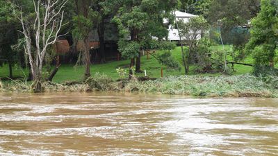 More rain forecast after town flooded, roads cut