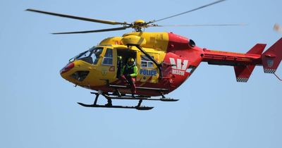 Search for missing man at Fingal Bay after wave sweeps four men of rocks