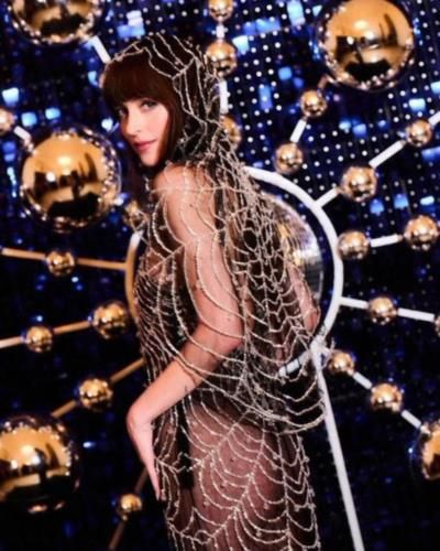 Dakota Johnson stuns in spider-web inspired look at film photocall