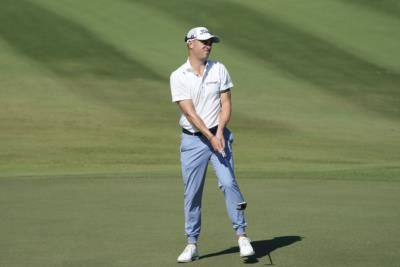 Justin Thomas Battling Strong Winds on Golf Course with Determination and Humor