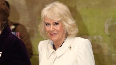 Queen Camilla wears leopard print and knee-high boots in bold winter styling moment