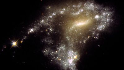 Hubble Space Telescope tells a starry 'tail' of 12 mingling galaxies