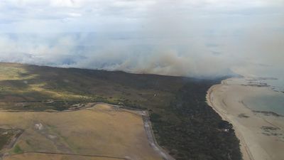 Bushfire downgraded after campers, residents evacuated