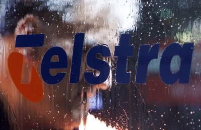 Telstra trims FY earnings, first-half profit rises