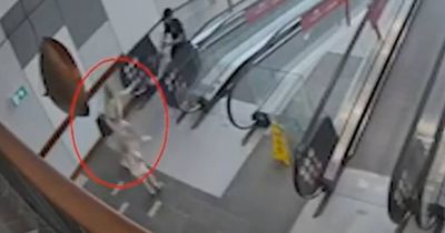 Watch: Woman foils alleged robbery getaway with child in hand