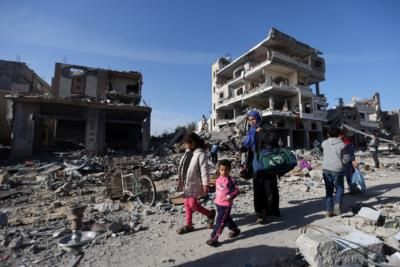 Displaced Palestinians fleeing Rafa due to intensified airstrikes, seeking shelter