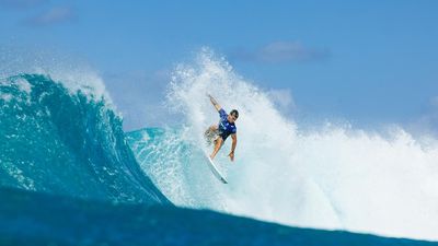 Three Aussie men charge into Sunset Pro surf quarters