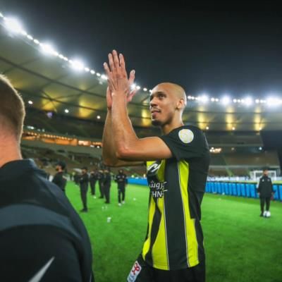 Fabinho celebrates with teammates and fans after significant match victory