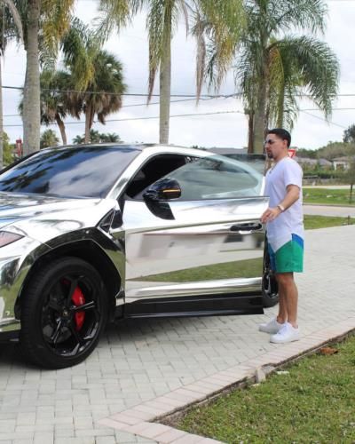 Danny Garcia's Stylish Adventures: Car Poses And Boating Thrills