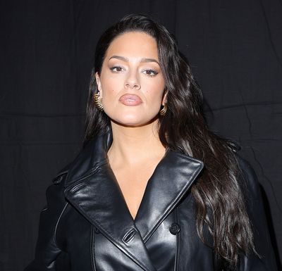 Ashley Graham Arrives at Milan Fashion Week in a Trench Coat Styled as a Dress