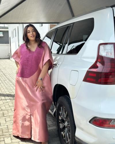 Adunni Ade Stuns In Pink Outfit Next To White Car
