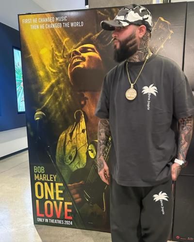 Farruko Poses With 'One Love' Movie Poster