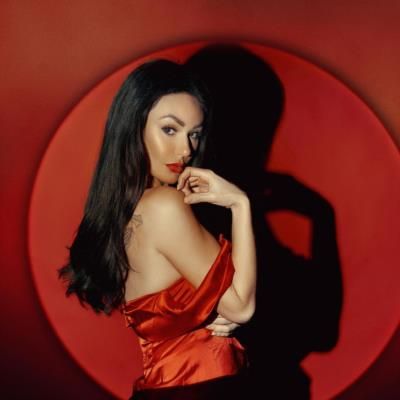 Jenni Farley Stuns In Striking Red Outfit Against Bold Backdrop
