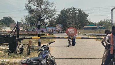 Residents erect banner for bridge to replace level crossing near Katpadi