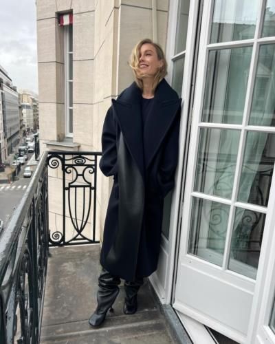 Brie Larson Stuns In Classic Black Coat On Balcony