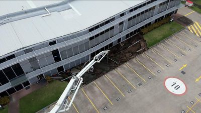 Concrete poured into sinkhole after building collapse