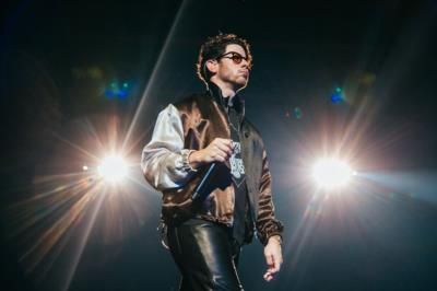 Capturing Nick Jonas' Dynamic Stage Presence And Style Through Photoshoots