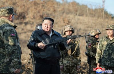 N. Korea's Kim Handles Gun As He Inspects Training Base