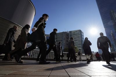 Japan’s economy narrowly avoids recession as growth figures revised
