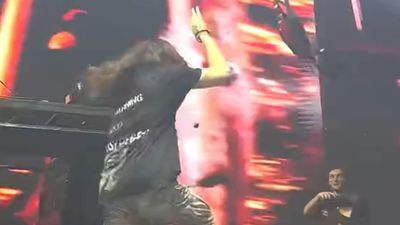 Watch this metal musician mistake a photographer for a technician and accidentally lob a guitar at him