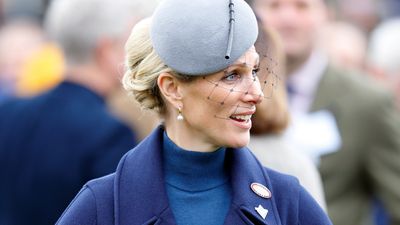 Zara Tindall nails bold tonal dressing in navy cape and matching accessories at Cheltenham