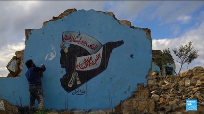 13 years on, Syrians in Idlib uphold revolution through street art, sky monitoring and rallies