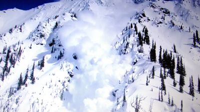 "Imagine being buried under thousands of these" – Utah ski patroller poses next to huge boulder-sized snowball