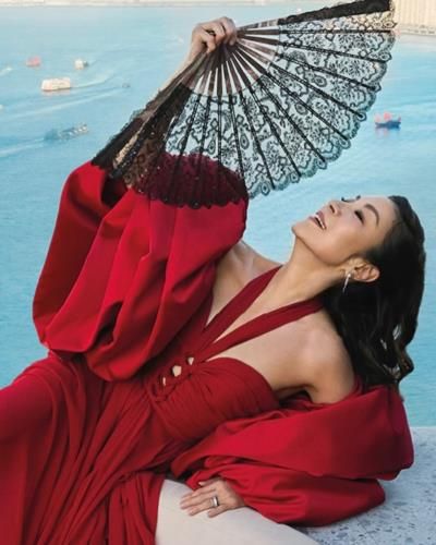 Michelle Yeoh Stuns In Vibrant Red Outfit And Black Fan