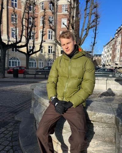 Anders Antonsen's Stylish Olive Green Jacket And Black Ensemble