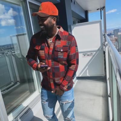 Franmil Reyes Sporting Vibrant Outfit With Blue Jeans And Orange Cap