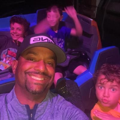 Alfonso Ribeiro And Child Enjoy Roller Coaster Fun At Disney