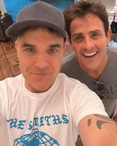 Robbie Williams Radiates Cool In White Tee With Friend