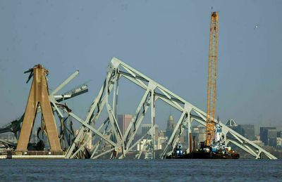 A giant crane arrives in Baltimore, but leaders see a 'daunting' cleanup job ahead