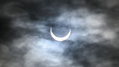 Why low-level clouds vanish during a solar eclipse