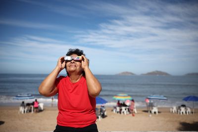 Mexico's beach party is excited to see the eclipse first emerge